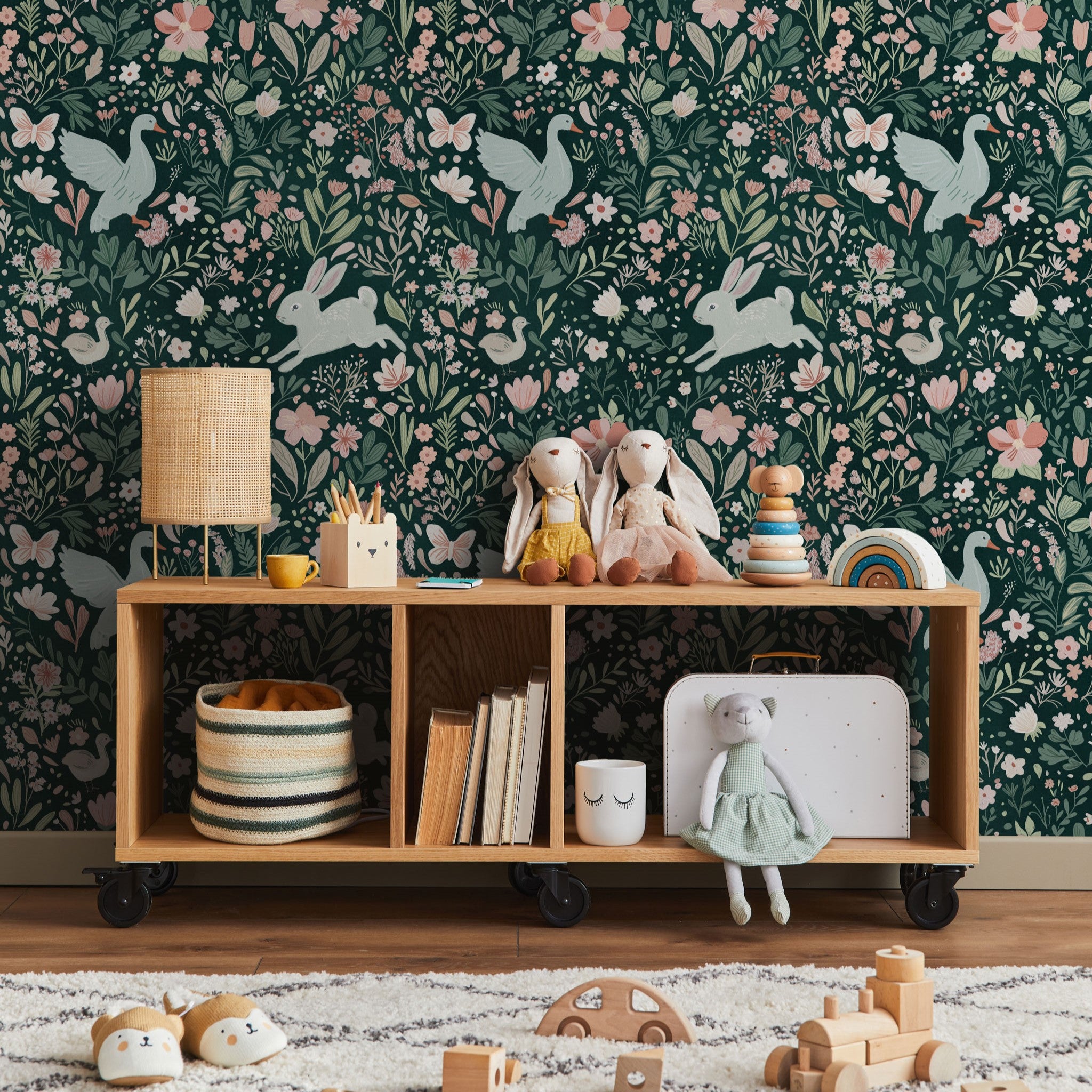 "Wall Blush's Wildwood Friends Wallpaper in cozy nursery room with playful animal design and children's toys."