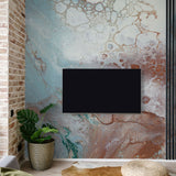 "Montage Wallpaper by Wall Blush featured in stylish living room with accent brick wall focusing on textured design."