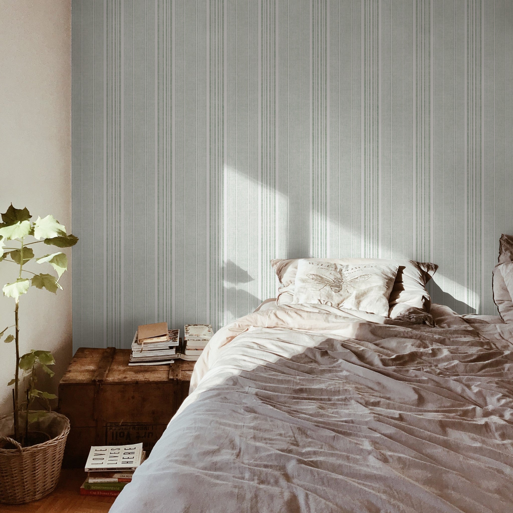"Small Town Wallpaper by Wall Blush in cozy bedroom, highlighting elegant stripes and soft light."