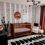 "Stylish nursery room featuring Wall Blush Arrow Wallpaper to create a modern and cozy space."