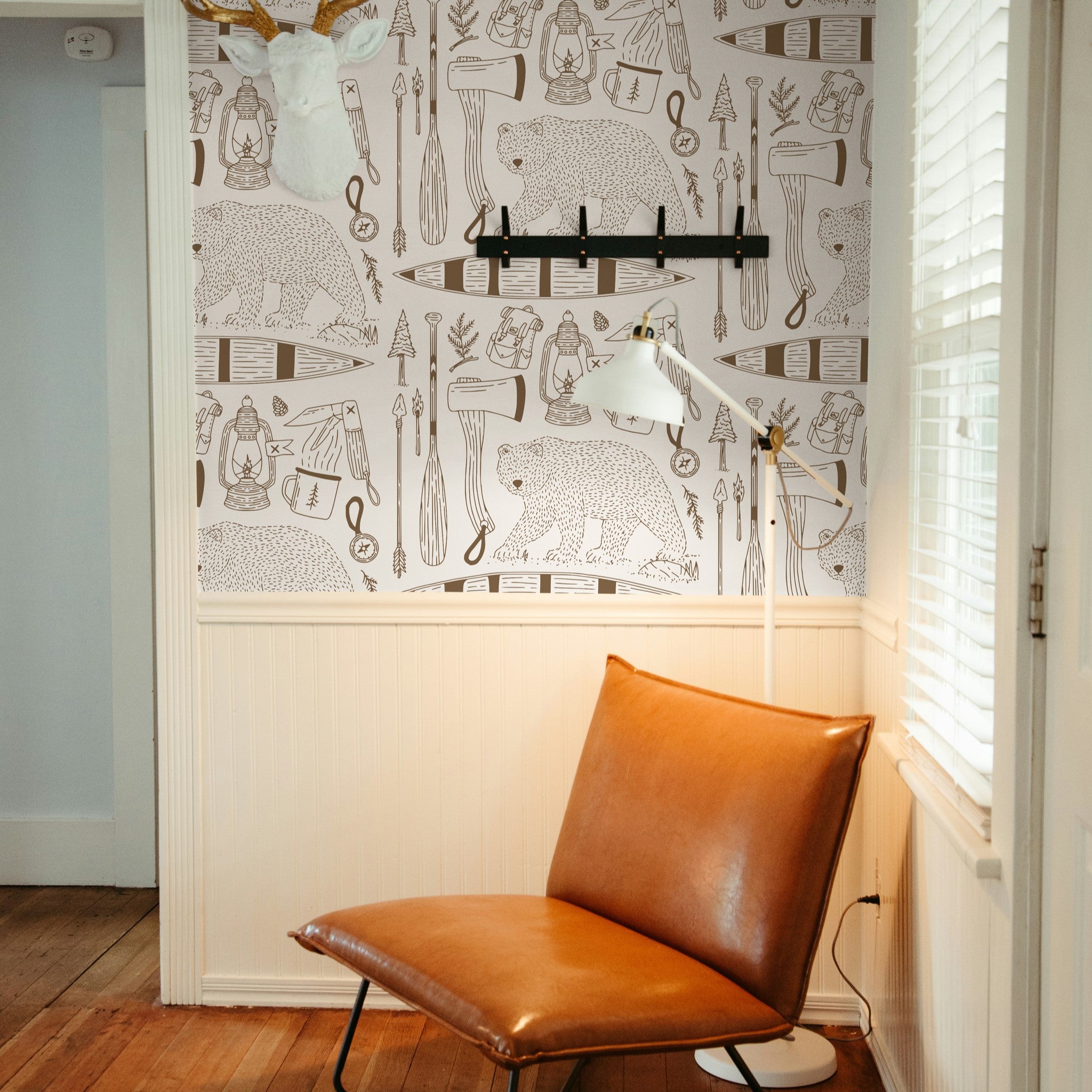 "Wall Blush Trail Blazer (Cream) Wallpaper in a cozy reading nook with leather chair and floor lamp."