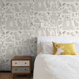 "Wall Blush Woodland Cream Wallpaper featured in a cozy bedroom setting, highlighting elegant and whimsical forest design."