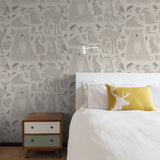 "Cozy bedroom featuring Wall Blush's Woodland (Tan) Wallpaper with animal patterns, accentuating a modern decor."