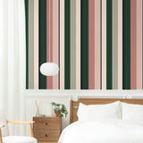 Alt: "Mitzy Wallpaper by Wall Blush featuring vertical stripes in modern bedroom setting, showcasing design focus."