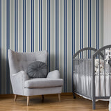 "Wall Blush Crue Wallpaper in a stylish nursery room with striped pattern, armchair, and crib."