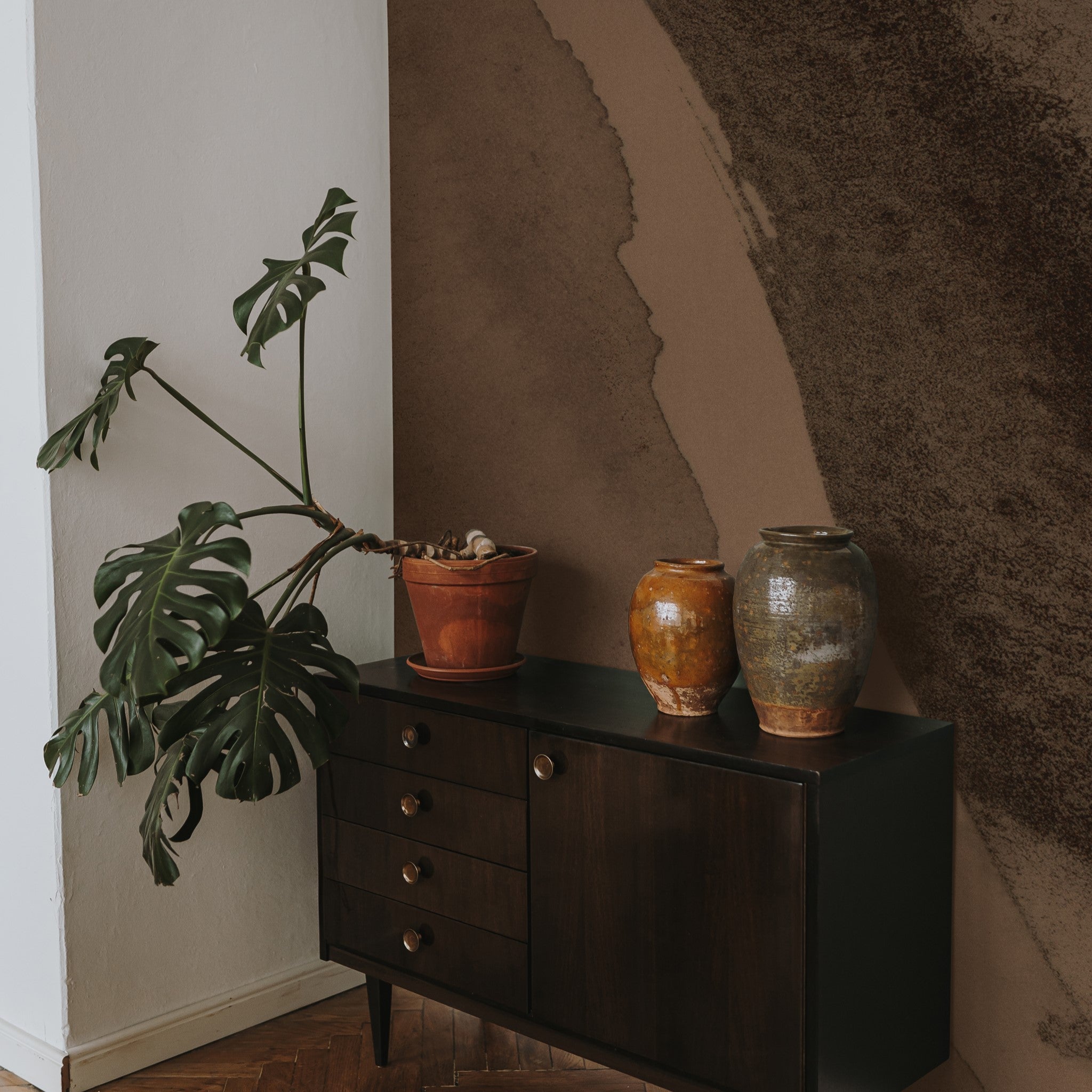 "Wall Blush's Chicago Wallpaper accentuating a modern living room decor with a sideboard and houseplants."