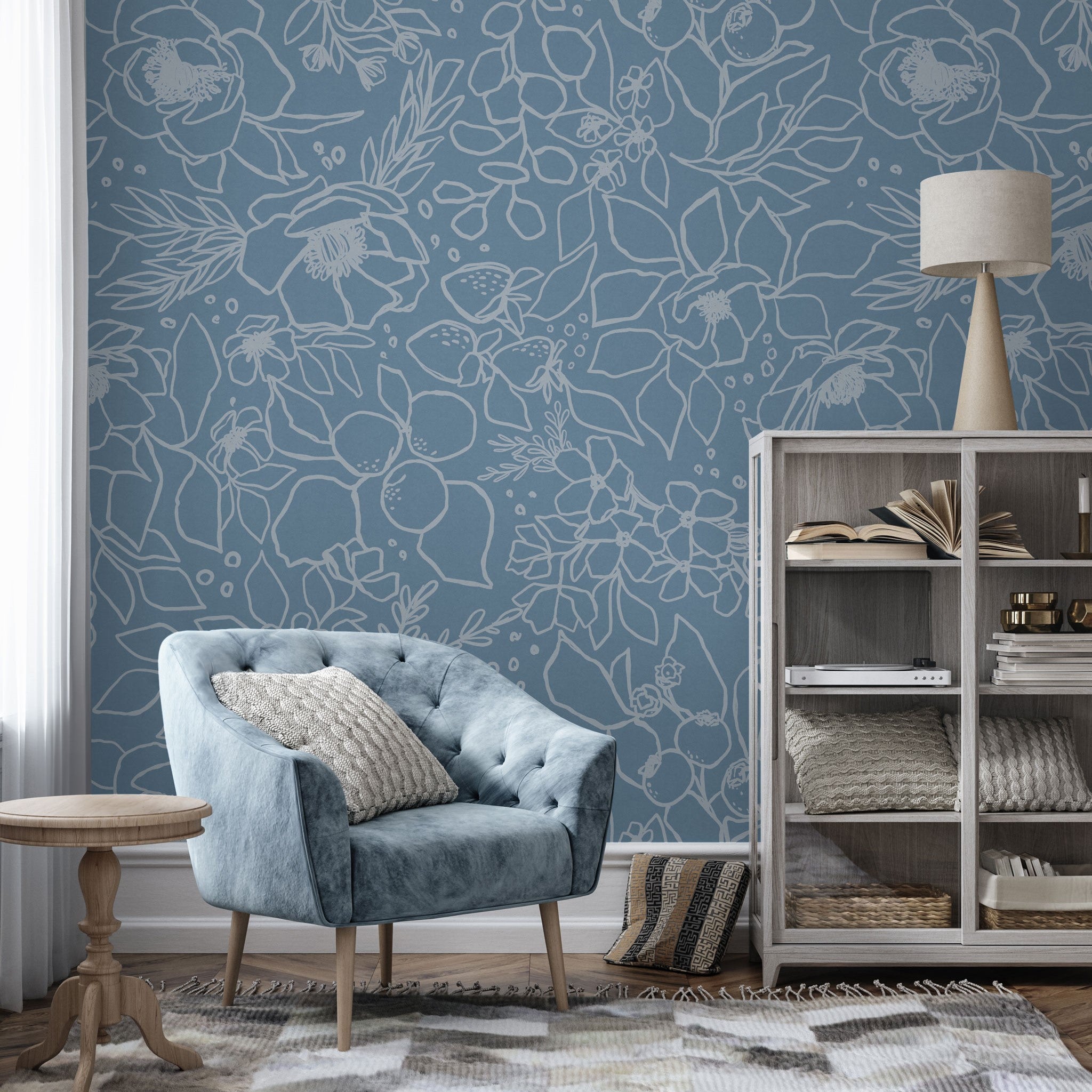 "Wall Blush 'Paige (Blue) Wallpaper' in a chic living room setting, cozy blue chair accentuating the floral design."