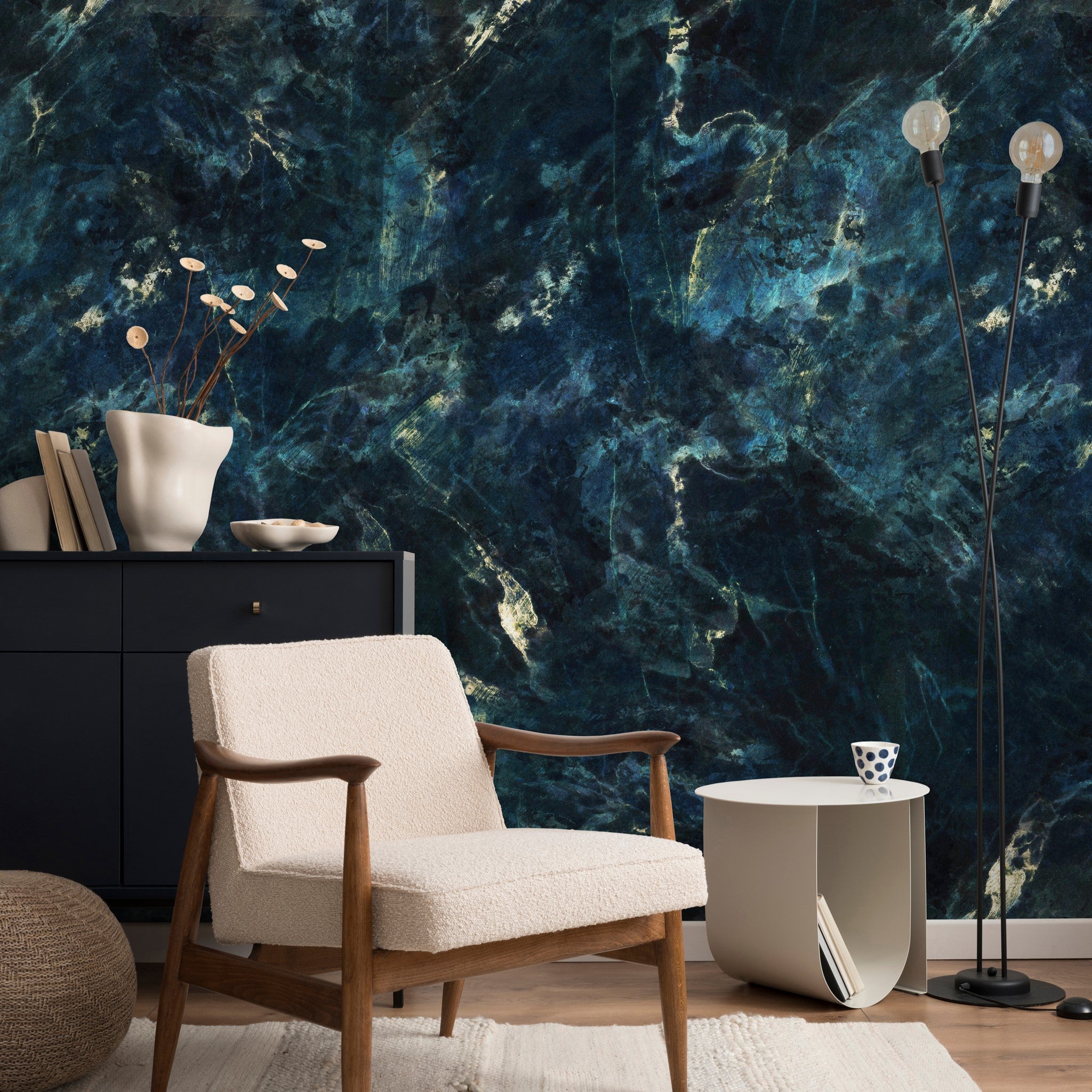 "Baudelaire Wallpaper by Wall Blush enhancing a modern living room's aesthetic with deep blue textured design."