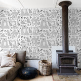 "Wall Blush Woodland Wallpaper in a cozy living room with fireplace and sofa, highlighting the whimsical animal patterns."