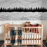 "Sea to Summit Wallpaper by Wall Blush styled in a nursery, monochrome mountain and tree design focus."