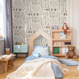 Alt: "Cozy child's bedroom with Wall Blush 'Trail Blazer (Cream) Wallpaper' highlighting playful patterns on the wall."