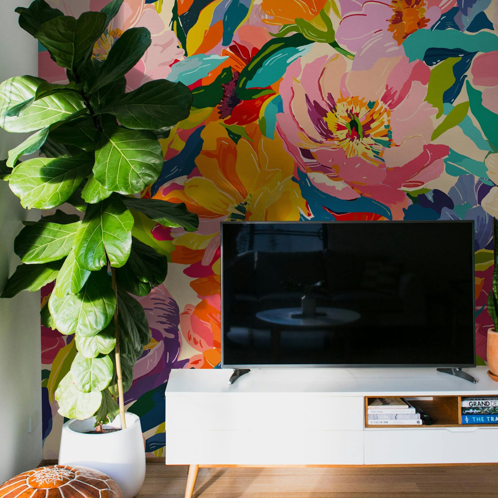 "Vibrant Rebbie Wallpaper by Wall Blush in a modern living room, featuring colorful floral design."