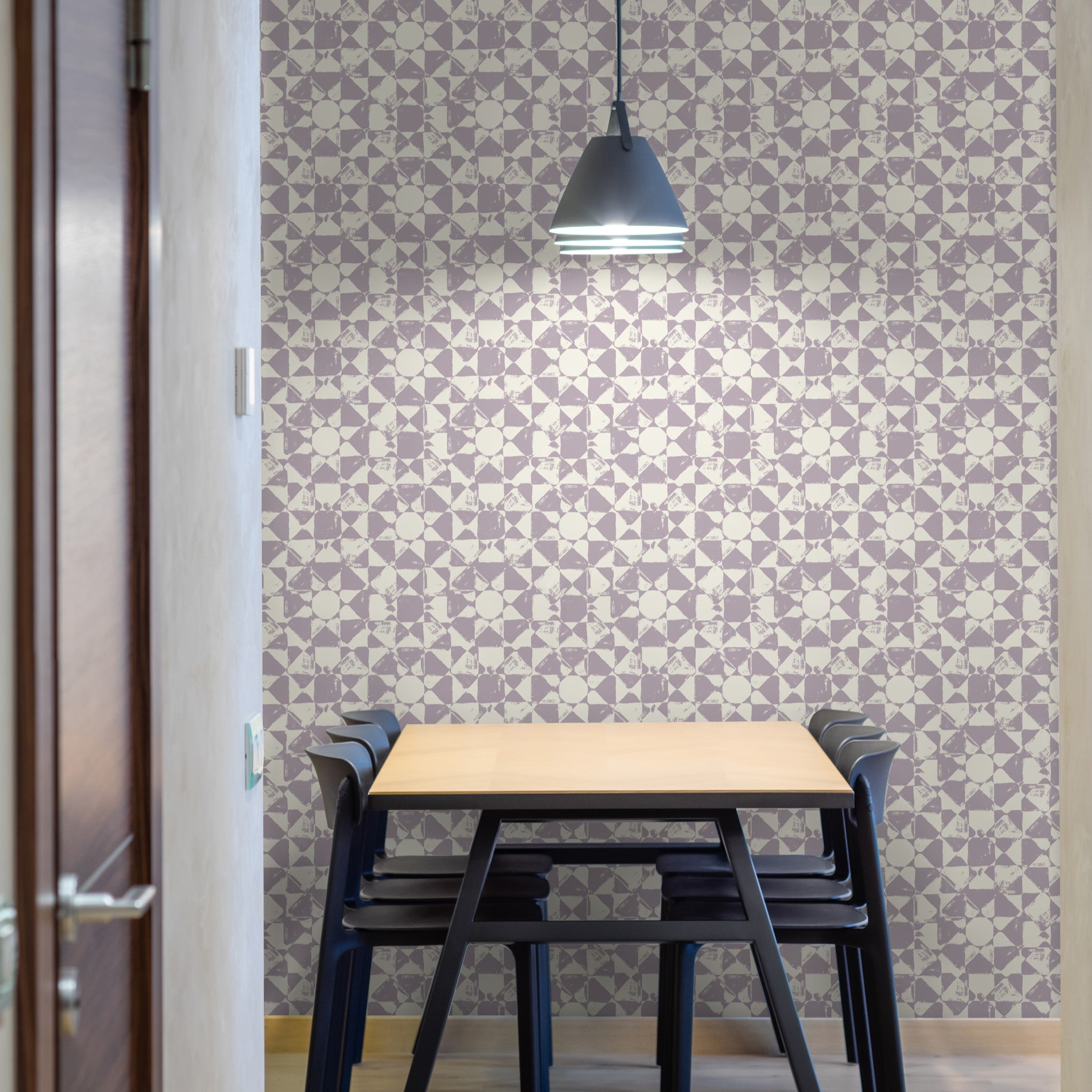 "Dining room featuring Wall Blush's Pascal Wallpaper with a geometric pattern and a modern pendant light."