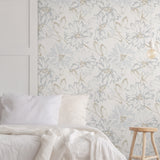 "Wall Blush's Something Blue Wallpaper in a serene bedroom setting, highlighting elegant floral design and cozy decor."