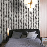 Sylvie Wallpaper by Wall Blush in a modern bedroom, black and white wavy pattern focus.