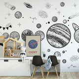 Alt text: "Wall Blush's Apollo Wallpaper featuring celestial designs in a stylish children's room with modern furniture."