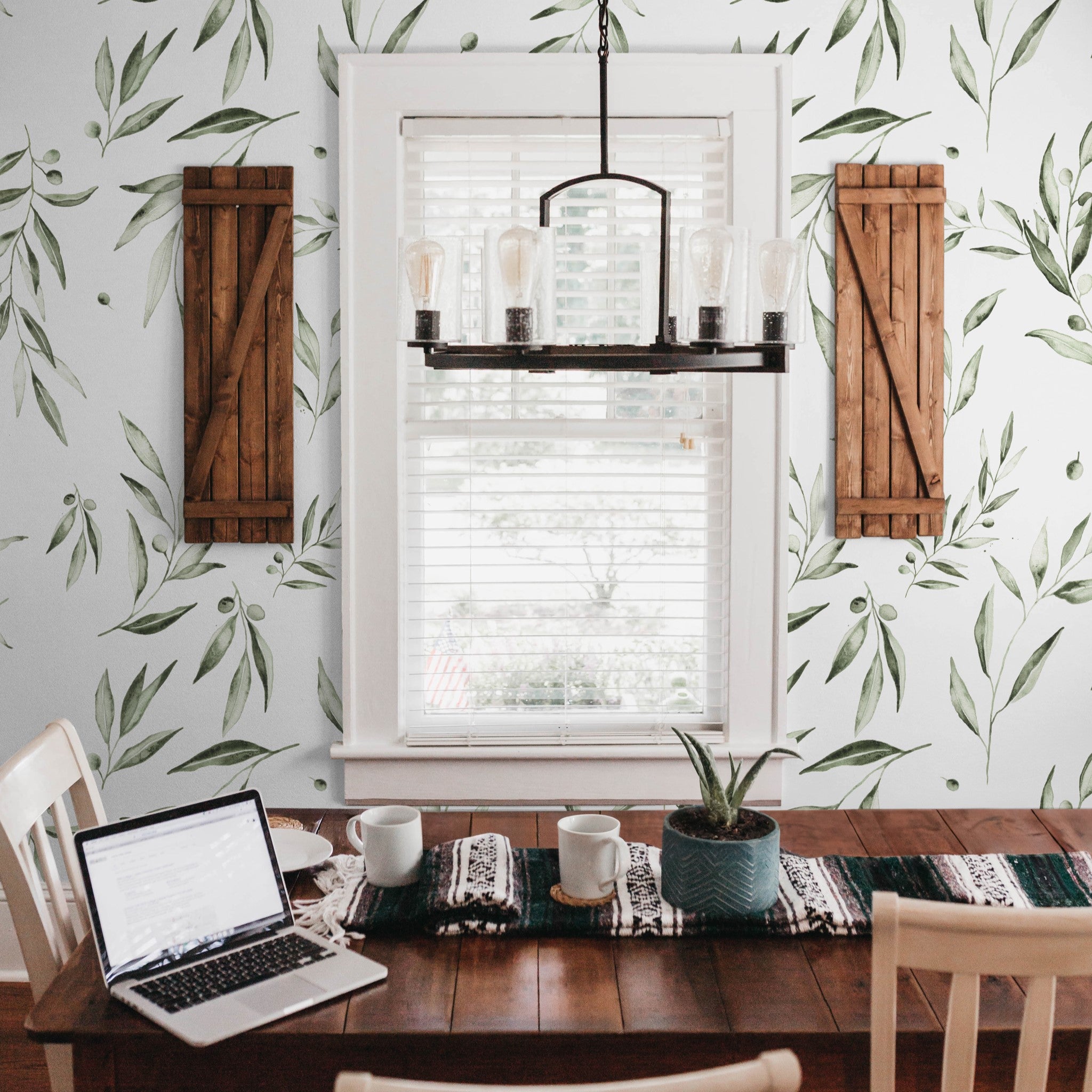 "Fiona Wallpaper by Wall Blush adorns a cozy dining room, highlighting the elegant botanical design."