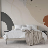 Wall Blush's American Honey Wallpaper in a modern bedroom, showcasing abstract design and neutral tones.
