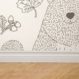 "Wall Blush Woodland Cream Wallpaper featuring nature patterns in a cozy living room setting."