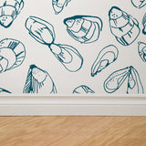 "Sebastian Wallpaper with marine life sketches by Wall Blush, accentuating a modern home's living room."