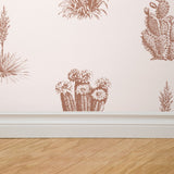 "Wall Blush Desert Cove Wallpaper featuring cactus print in a modern living room setting, with focus on design and texture."