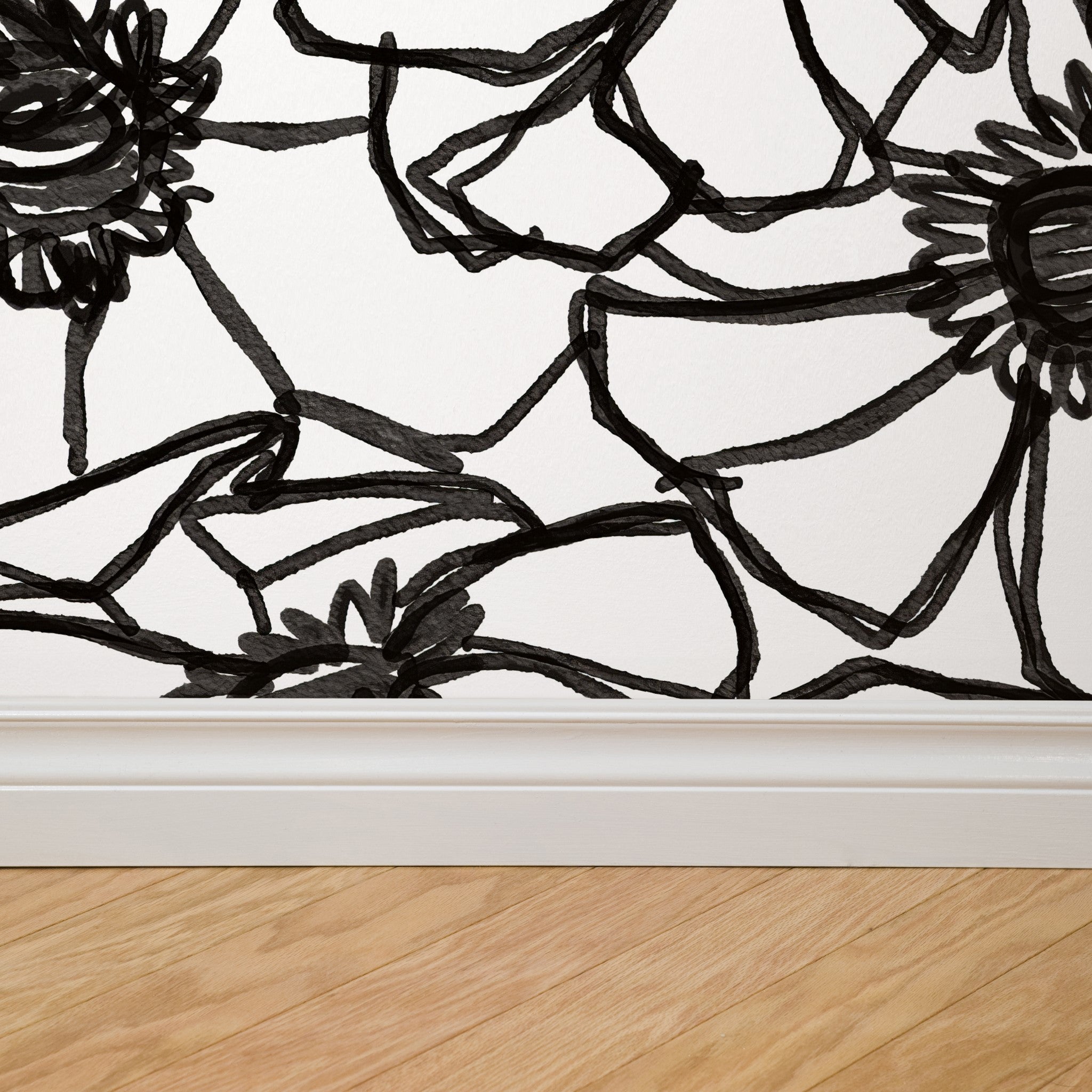 "Wall Blush's Inked Blossom Wallpaper in a modern living room, showcasing elegant floral design as the focal point."