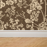 "Burnett Wallpaper by Wall Blush in a modern room, with a floral pattern focus on the wall above hardwood flooring."