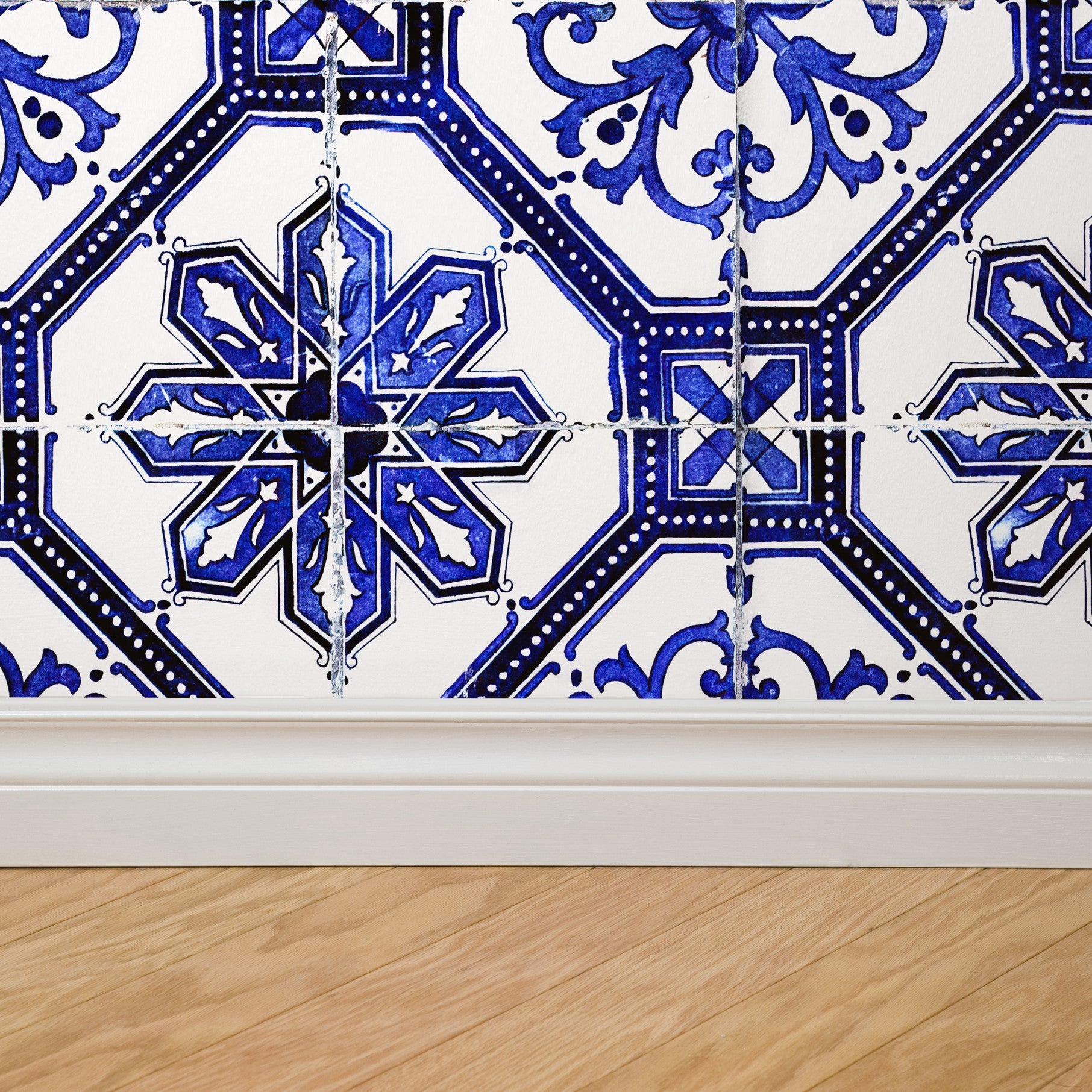 "Wall Blush Alma Wallpaper featuring intricate blue patterns in a stylish living space, focusing on the wall decor."