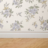 "Wall Blush Little Miss Wallpaper featured in a modern living room, elegant floral designs enhancing home decor."