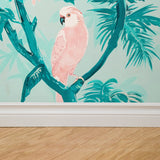 "Tropical Kawaii Wallpaper by Wall Blush in stylish living room, with vivid pink parrot design."