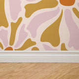 "Wall Blush Lila Wallpaper featuring abstract design, enhancing a modern living room's decor."