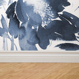 "Wall Blush's Wild Blues Wallpaper featured in a modern living room, highlighting elegant floral patterns."