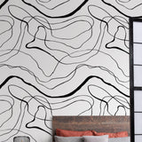 Belmore Wall Blush AW01 wallpaper in a modern bedroom with abstract design focus.
