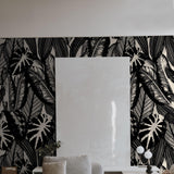 Chloe Wallpaper from The Stefanie Bloom Line in a modern living room, showcasing bold leaf patterns.
