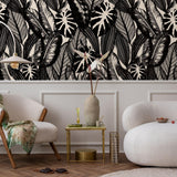 Chloe Wallpaper from The Stefanie Bloom Line enhancing a modern living room's ambiance with a bold tropical pattern.
