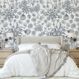 "Wall Blush's Denim Fields Wallpaper showcasing a floral pattern in a cozy bedroom setting with elegant decor."