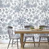 "Dining room with Wall Blush Denim Fields Wallpaper, elegant floral design focused behind wooden table and chairs."