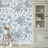 "Denim Fields Wallpaper by Wall Blush enhancing a rustic kitchen's decor with its floral design."