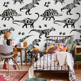 Child's bedroom featuring Wall Blush's Dino Rush Wallpaper with playful dinosaur pattern.
