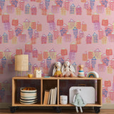 "Dream House Wallpaper by Wall Blush in a children's room with colorful house patterns, highlighting the design on the walls."