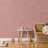 The Dutchess (Pink) Wallpaper from The Ania Zwara Line in a cozy children's room with floral patterns.
