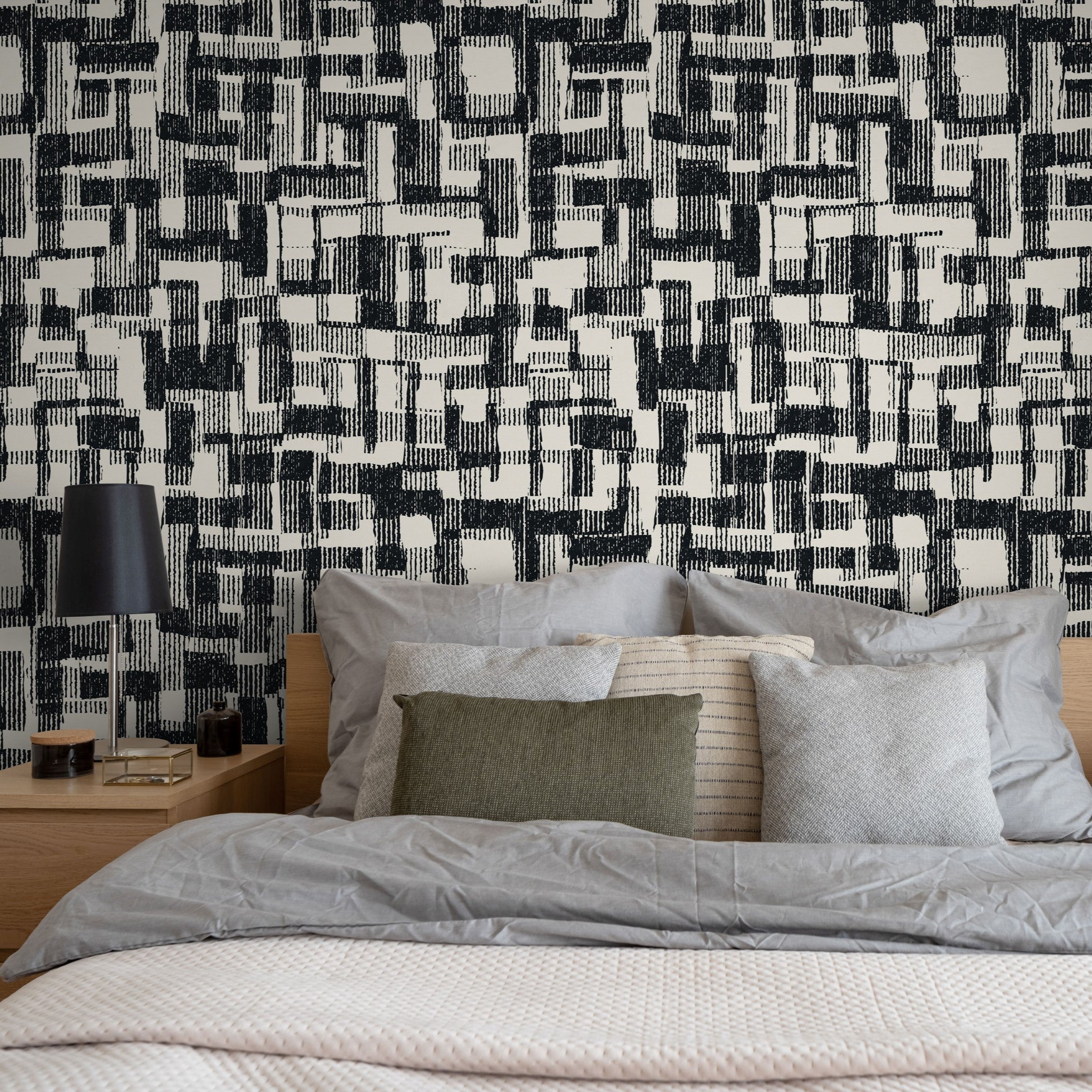 "Ezra Wallpaper by Wall Blush in a modern bedroom, featuring a bold black and white patterned wall."