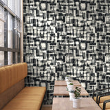 Ezra Wallpaper by Wall Blush adorning modern dining area with striking pattern focus.