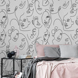 Bella Donna design from Wall Blush AW01 as bedroom wallpaper, with artistic face illustrations.
