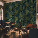 "Wall Blush Fraser Wallpaper in a stylish dining room with vibrant green tropical pattern focus"