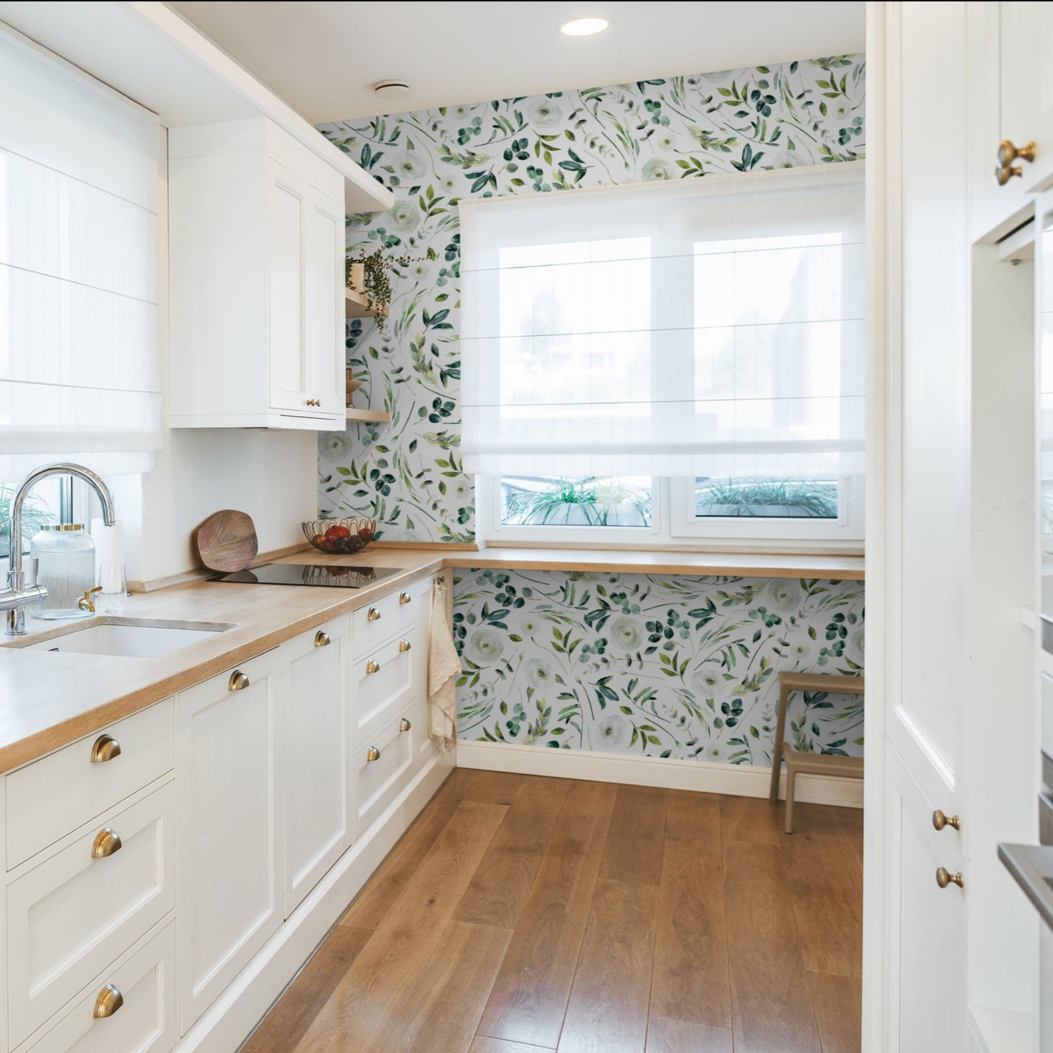 "Wall Blush Green Valley Wallpaper accent in modern kitchen, with white cabinets and wooden floor."