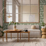 "Wall Blush's Kingston Wallpaper in a stylish living room, highlighting elegant green floral patterns."