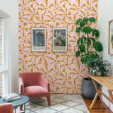 Alt: "Bright Lila Wallpaper by Wall Blush accentuating a cozy living room wall with modern decor and plants."