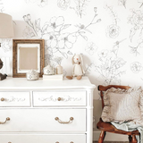 "Lined Meadow Wallpaper by Wall Blush in a cozy bedroom, with the focus on the floral design."