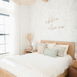 "Serene bedroom showcasing Wall Blush's Lined Meadow Wallpaper, highlighting elegant floral design and modern decor."